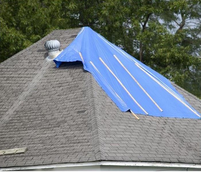 storm damaged roof tarped